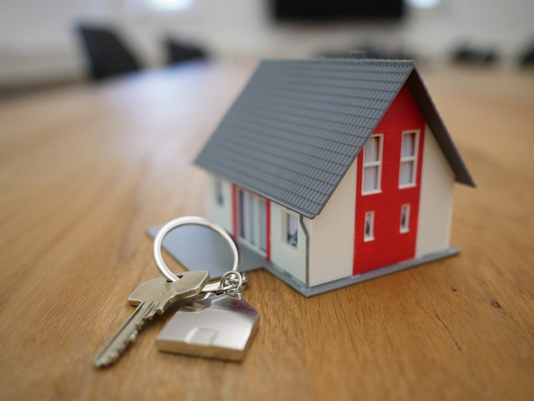 Toy house and keys on a table